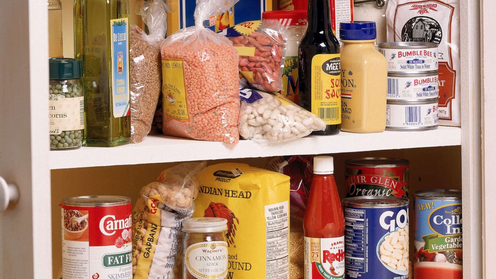 PHOTO: a stocked pantry. food in cupboard.