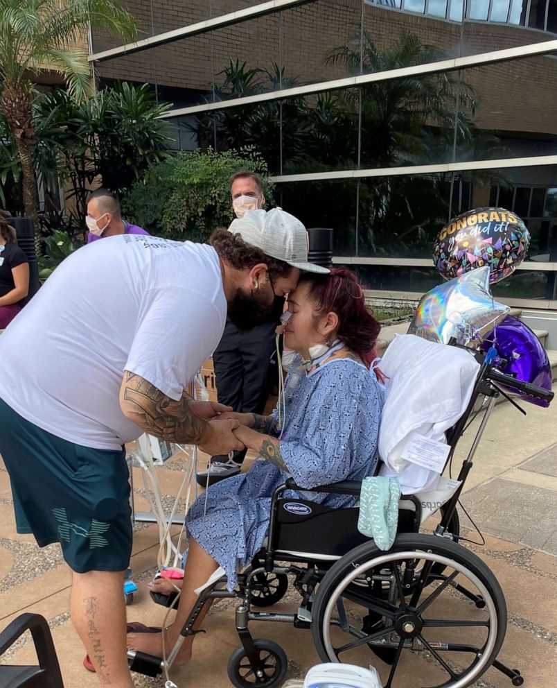 PHOTO: Paola Gambini, 32, hugs her fiance Michael Hazen while hospitalized following COVID-19.
