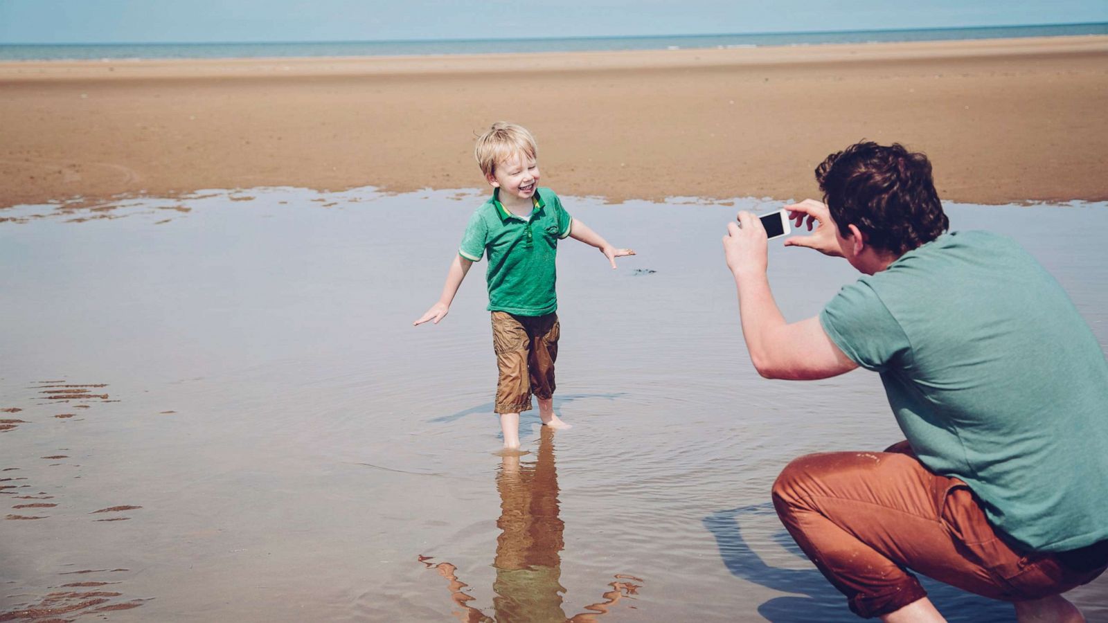 PHOTO: A father takes a pihoto of his son with a smart phone in this undated stock image.