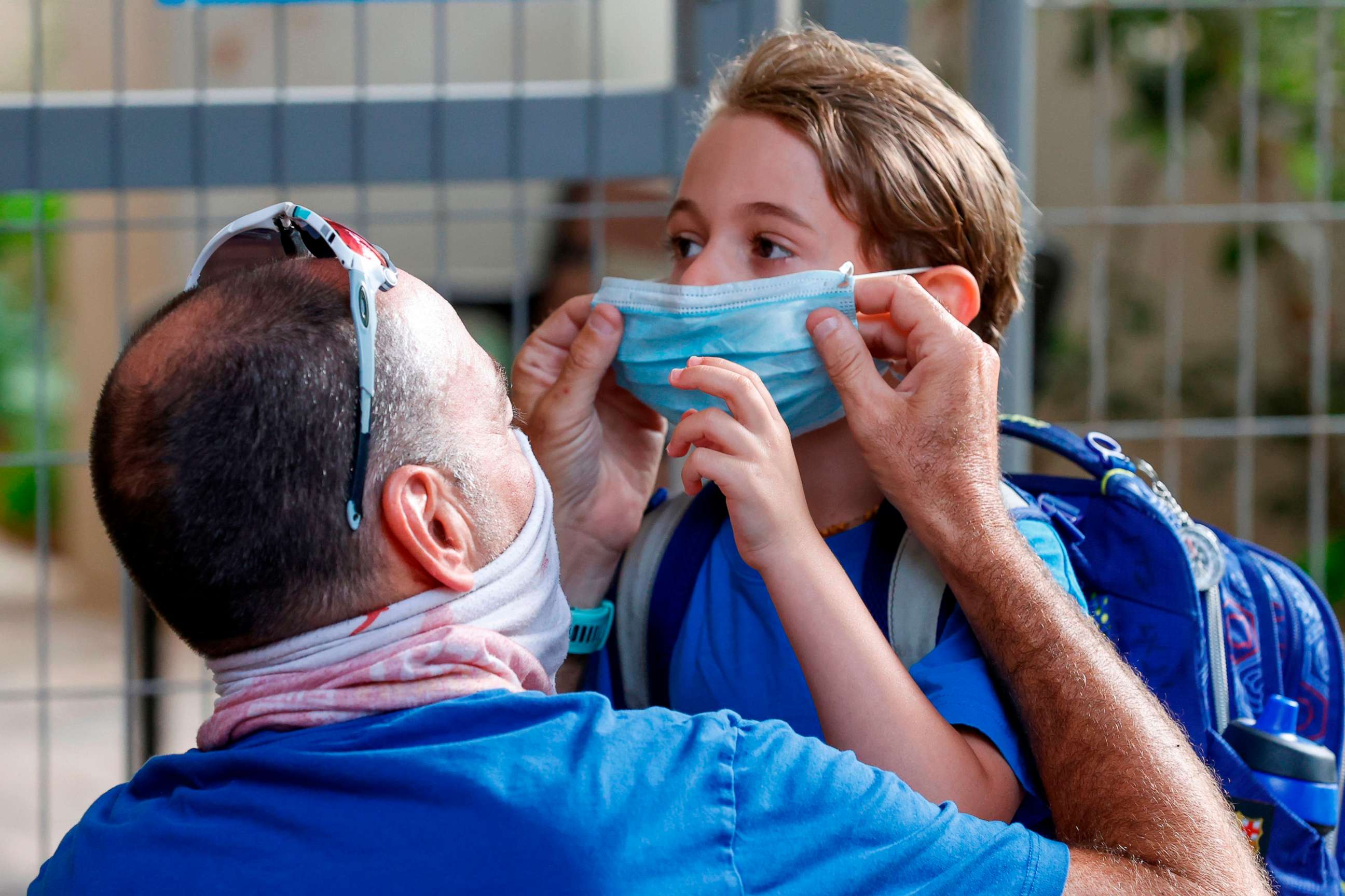PHOTO: An father adjusts the face mask of his daughter on the first day of school, during the coronavirus pandemic, in the Israeli coastal city of Tel Aviv on Sept. 1, 2020.