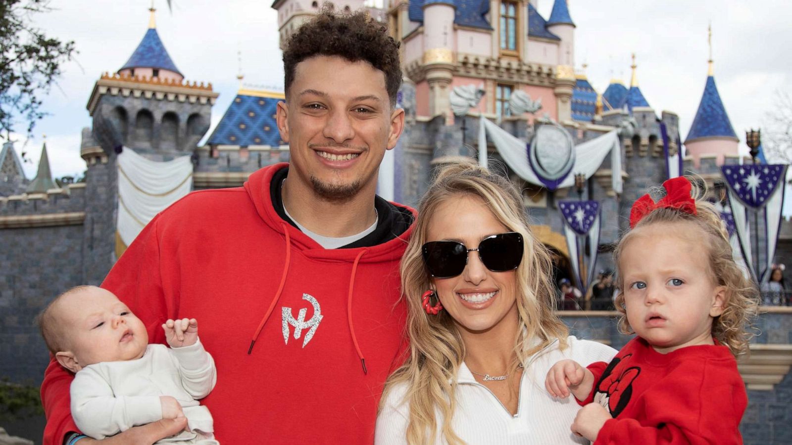 PHOTO: Patrick Mahomes of the Kansas City Chiefs and Brittney Mahomes pose with their children, Sterling, 1, and Bronze, 11 weeks old, in front of Sleeping Beauty Castle at Disneyland Park on February 13, 2023, in Anaheim, Calif.