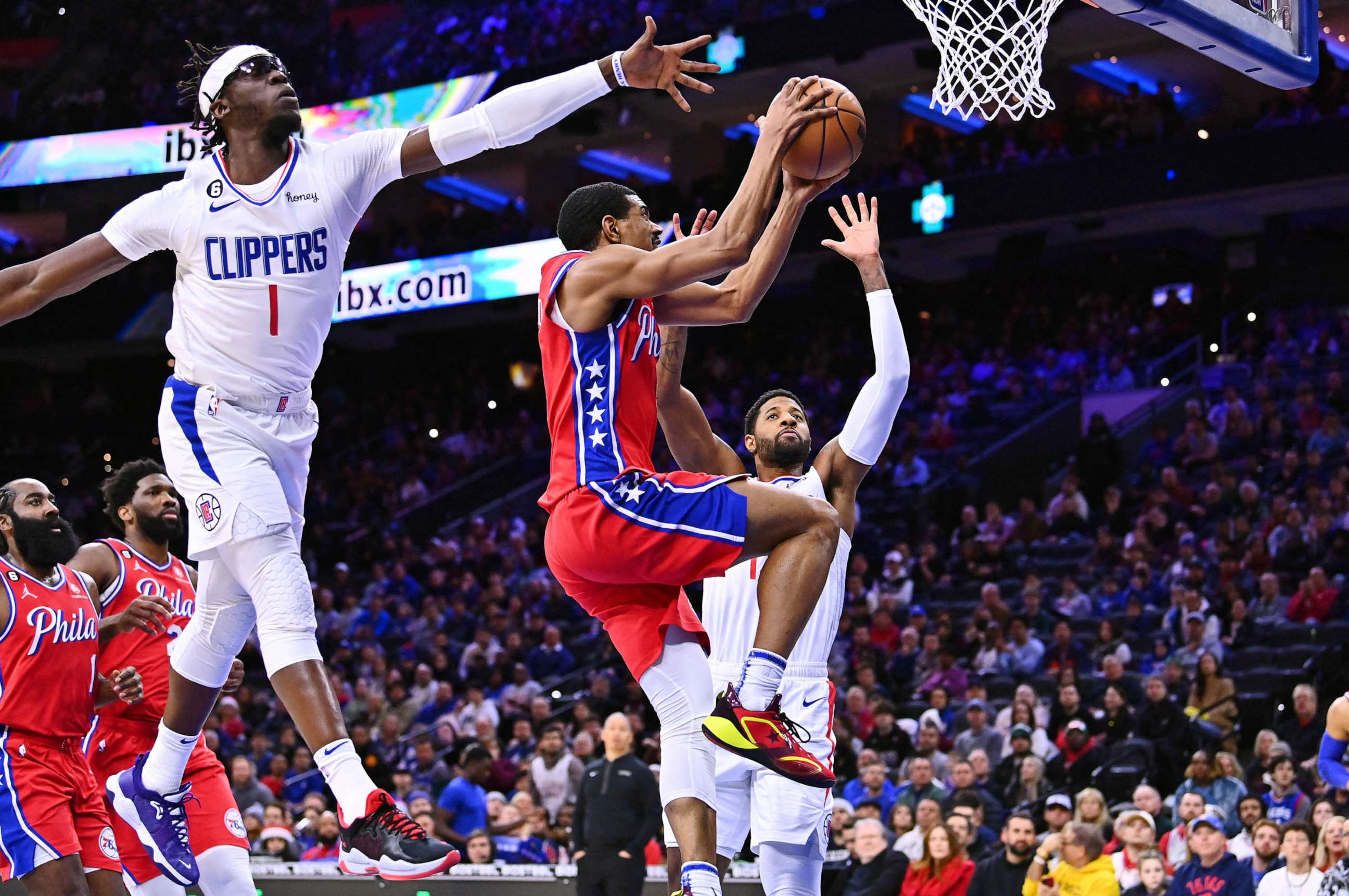PHOTO: Philadelphia 76ers guard De'Anthony Melton (8) shoots against Los Angeles Clippers guard Reggie Jackson (1) and forward Paul George (13) in the first quarter at Wells Fargo Center.