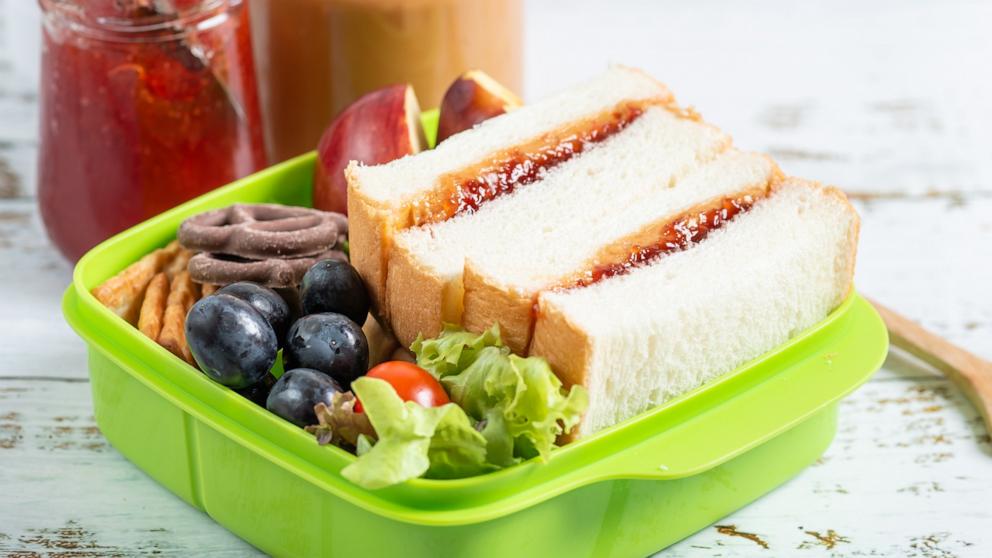 PHOTO: Lunch box of peanut butter with strawberry jam sandwich with crackers and fruit.