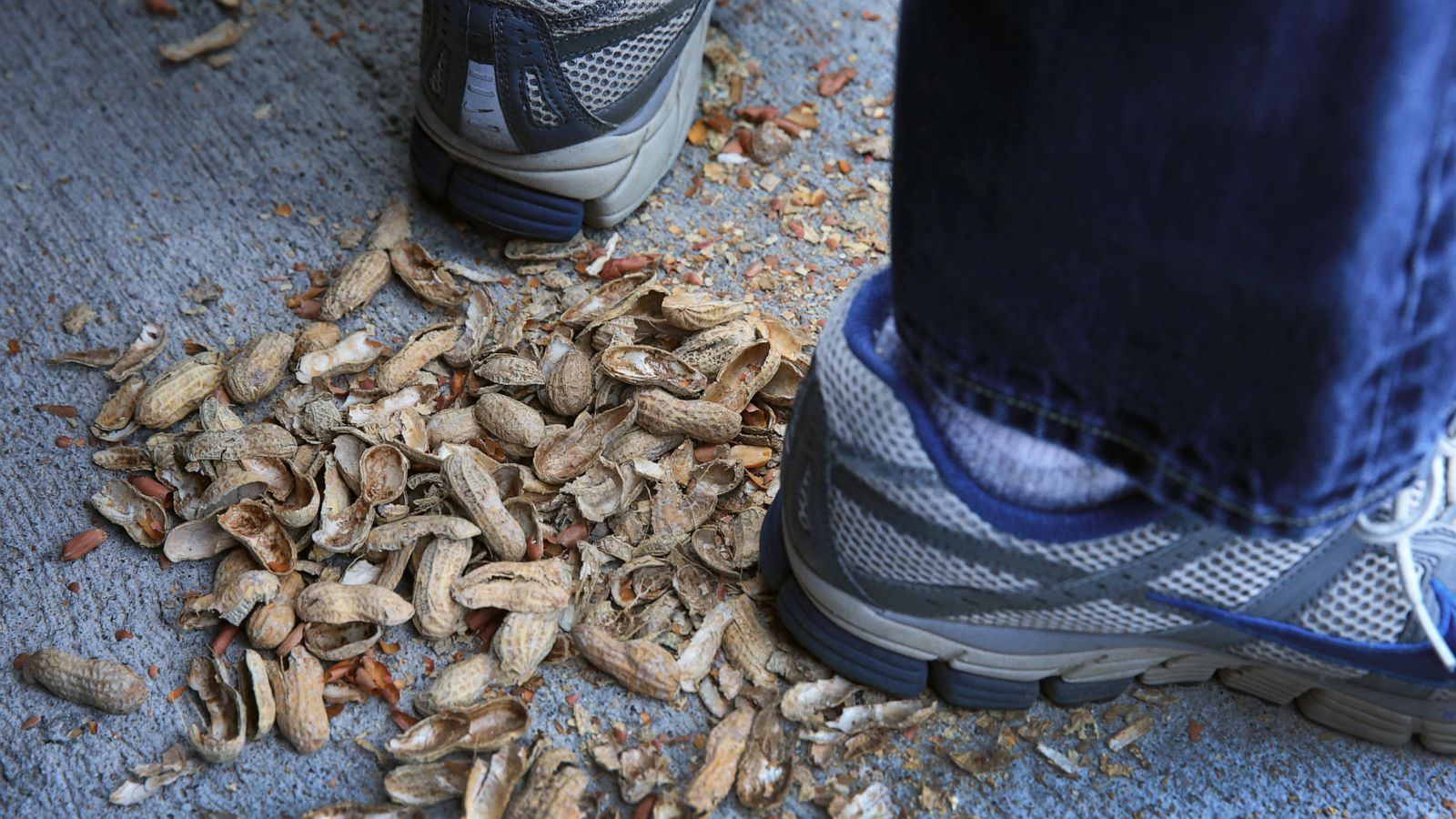 PHOTO: Empty peanut shells are seen beneath shoes during Opening Day at Fenway Park.