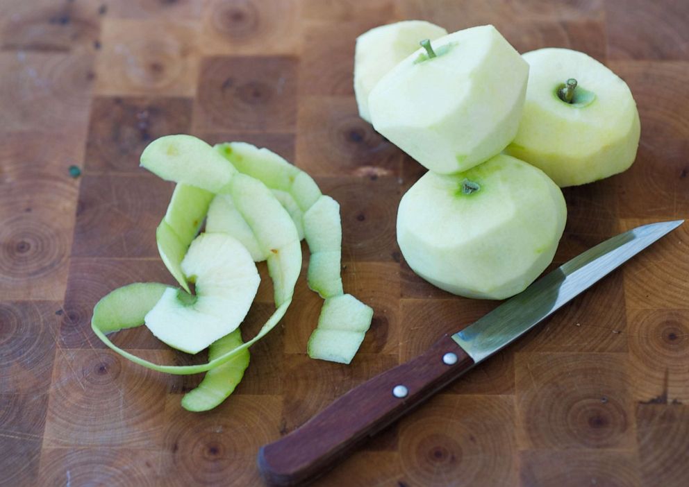 PHOTO: Peeled apples are shown on a cutting board.