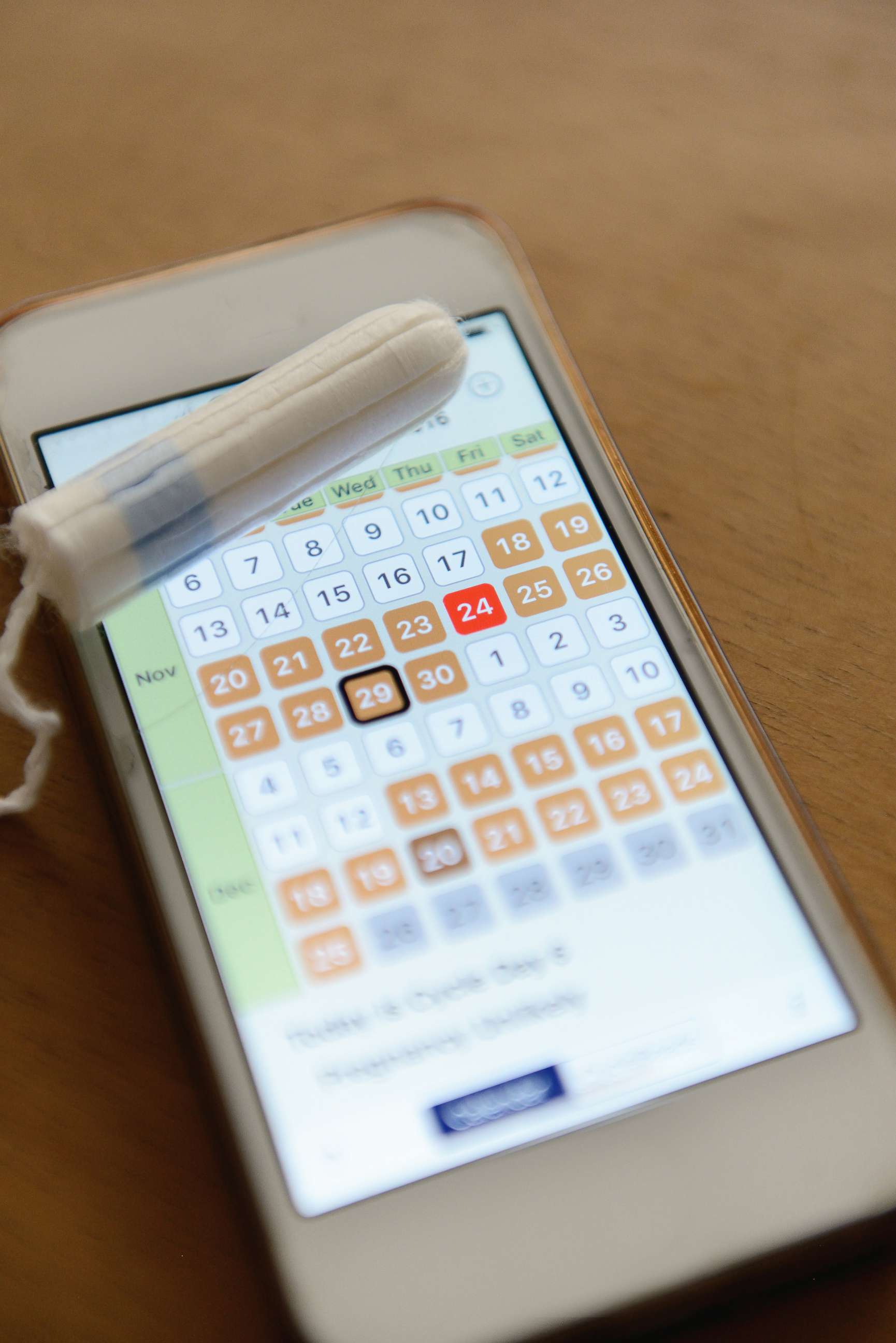 PHOTO: Period tracker app on a smart phone with a tampon.