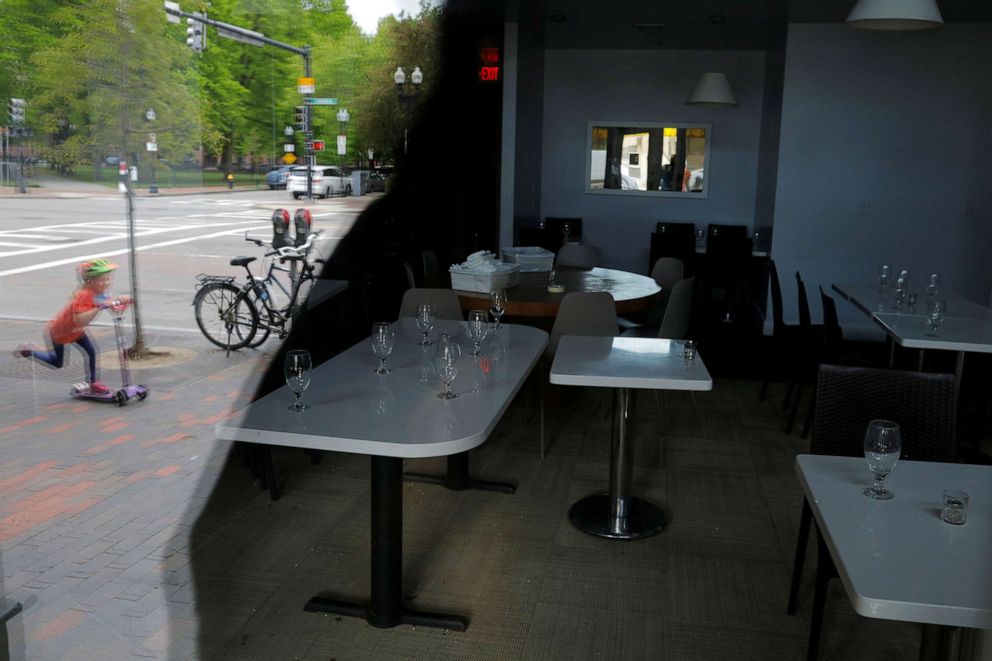 PHOTO: Tables with glassware on them are seen in Stella Restaurant, which announced it is closing permanently, amid the coronavirus disease outbreak in Boston, May 18, 2020.