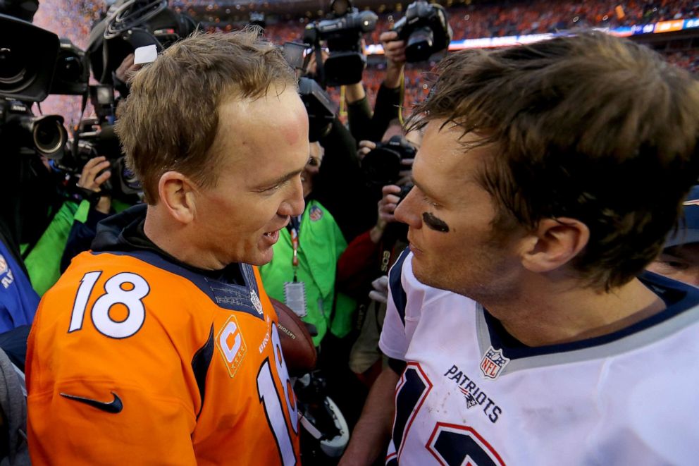 PHOTO: Peyton Manning and Tom Brady speak after the AFC Championship game at Sports Authority Field at Mile High on Jan. 24, 2016 in Denver.