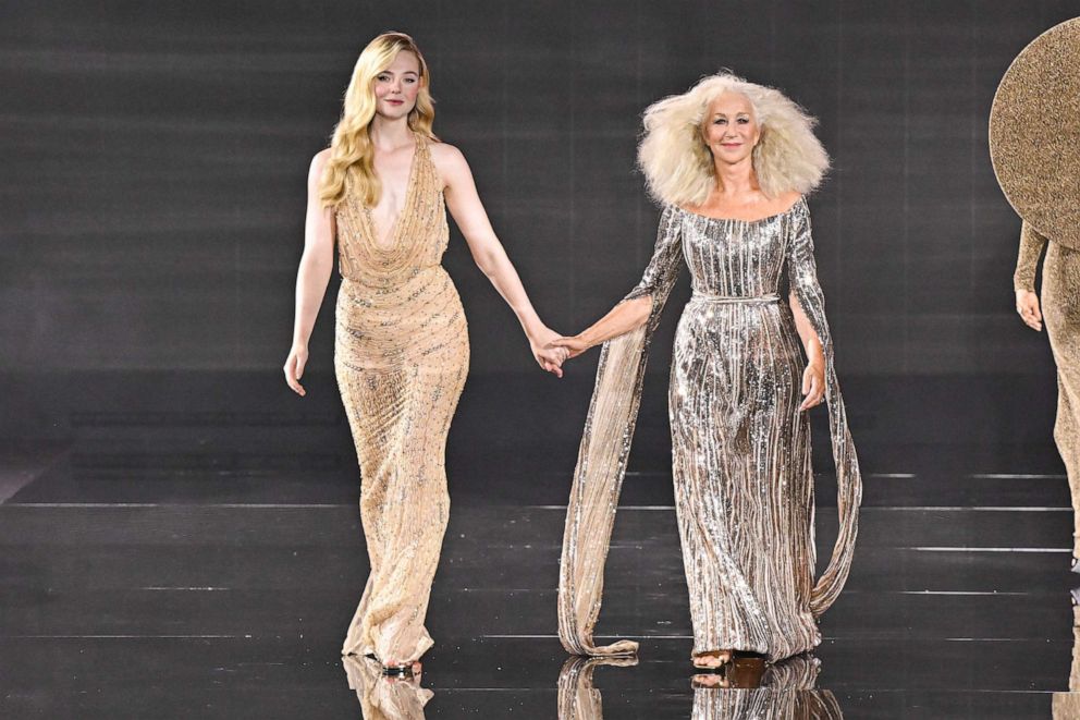 PHOTO: Elle Fanning and Helen Mirren walk the runway during "Le Défilé L'Oréal Paris - Walk Your Worth" Show as part of Paris Fashion Week at the Eiffel Tower, Oct. 1, 2023, in Paris.