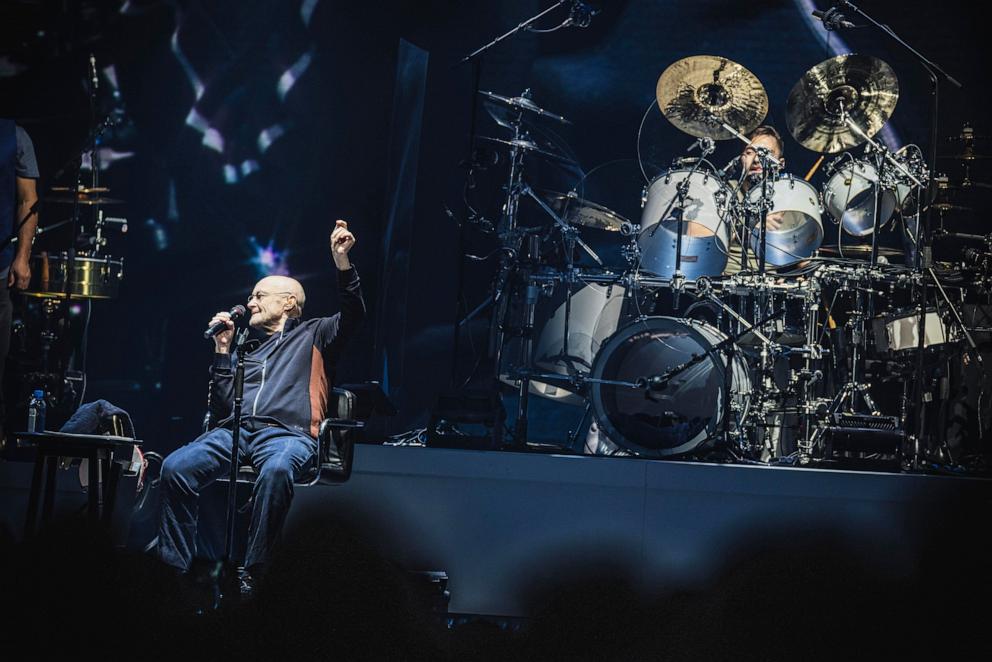 PHOTO: In this March 7, 2022, file photo, British singer and drummer Phil Collins and his son Nic Collins (drummer) of the band Genesis perform live on stage during a concert at Mercedes Benz Arena in Berlin.