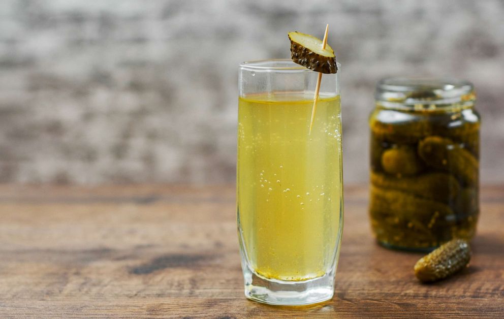 PHOTO: In an undated stock photo, pickle juice is seen in a glass next to a jar of pickles.