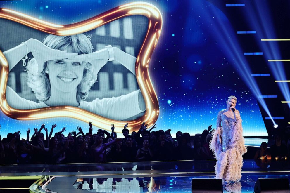 PHOTO: An image of the late Olivia Newton-John is displayed on a screen while Pink performs onstage during the 2022 American Music Awards, Nov. 20, 2022 in Los Angeles.