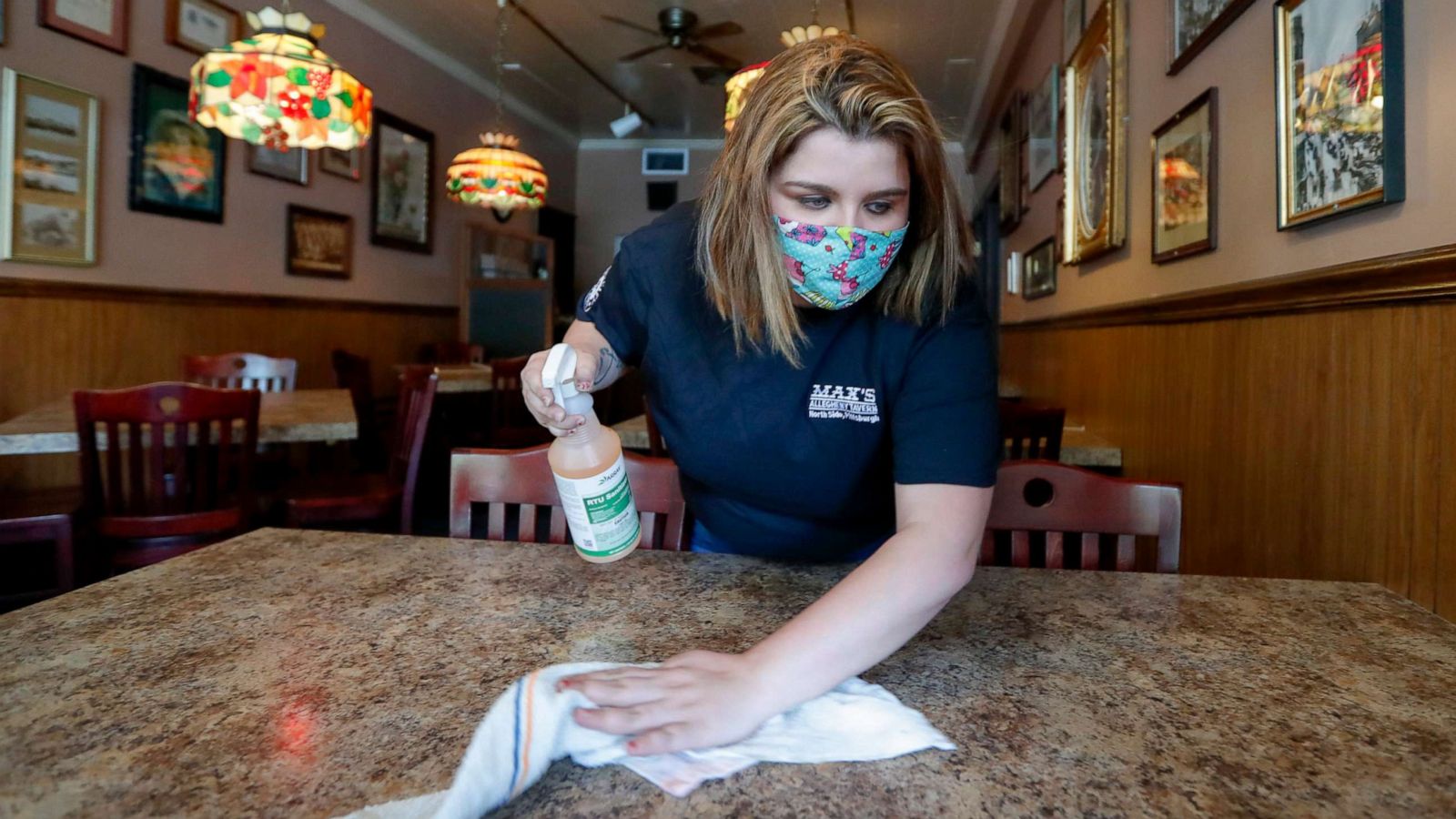 PHOTO: A worker cleans one of the dining tables at Max's Allegheny Tavern in Pittsburgh, June 4, 2020.