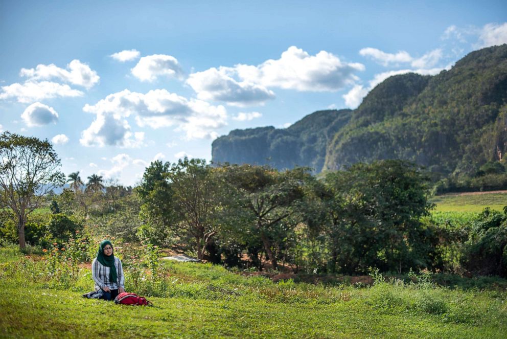 PHOTO: A woman prays in a field in Cuba. 