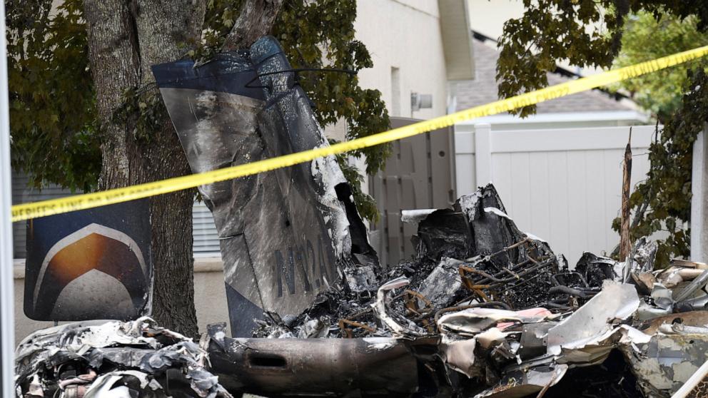 PHOTO: Wreckage from a small plane lies behind homes in the Grand Oaks subdivision after it crashed into residential backyards, in Pasco County, Fla., April 19, 2026. 