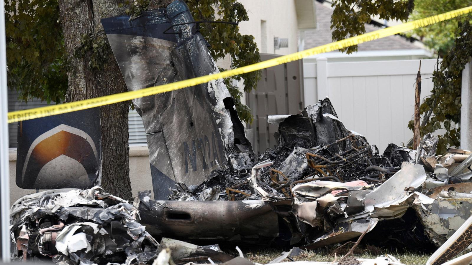 PHOTO: Wreckage from a small plane lies behind homes in the Grand Oaks subdivision after it crashed into residential backyards, in Pasco County, Fla., April 19, 2026.