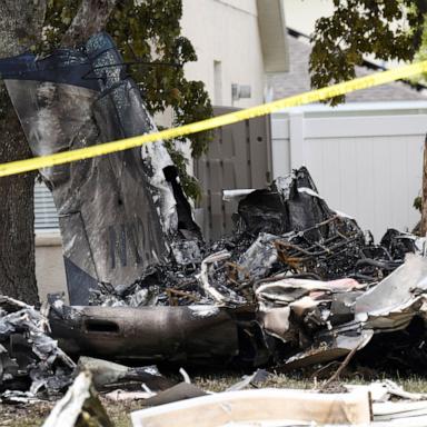 PHOTO: Wreckage from a small plane lies behind homes in the Grand Oaks subdivision after it crashed into residential backyards, in Pasco County, Fla., April 19, 2026. 