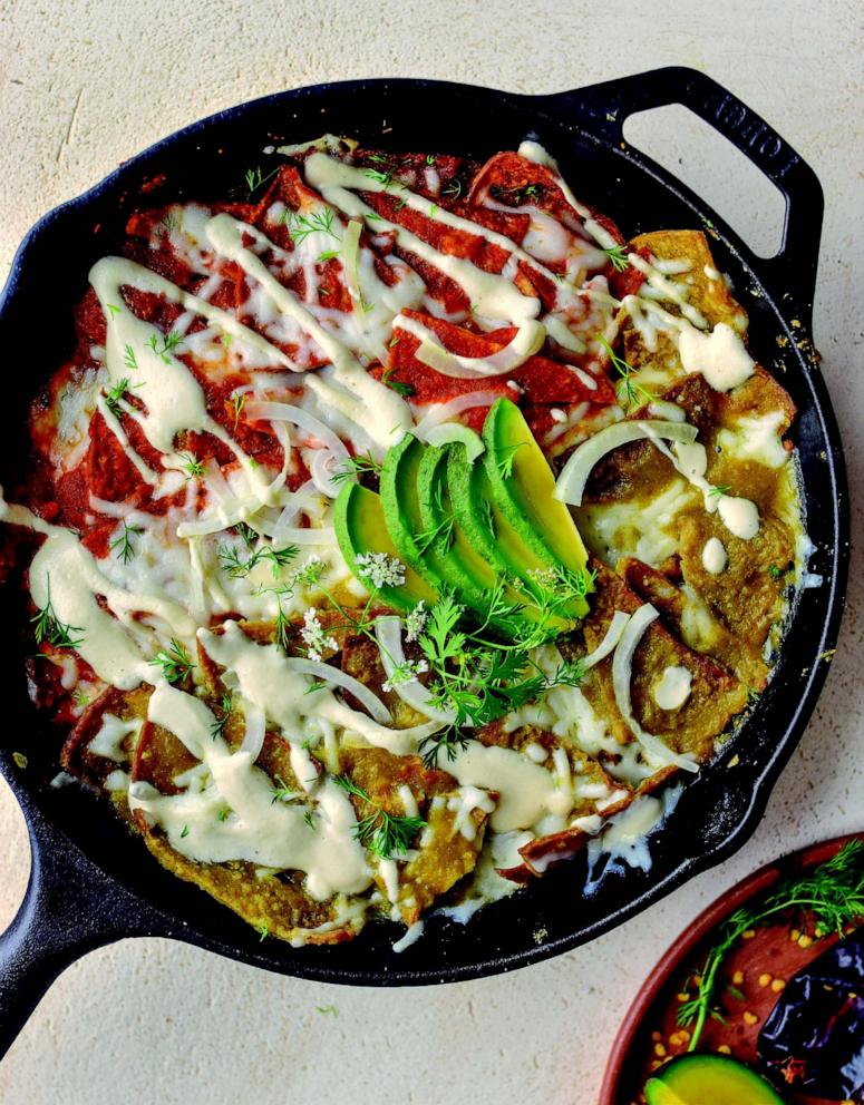 PHOTO: A plate of Chilaquiles topped with salsa roja and salsa verde.