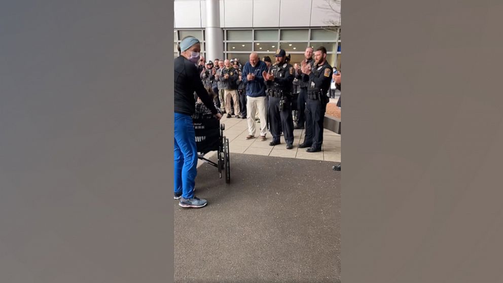 PHOTO: Members of the Bristol Police Department in Connecticut lined up to greet Laura DeMonte and her newborn daughter Penelope as she left a New Haven hospital.