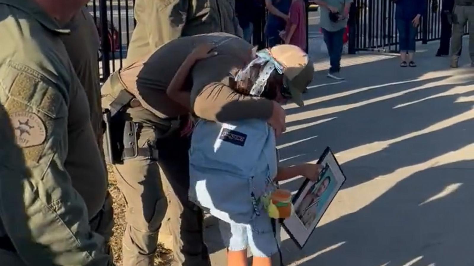 PHOTO: Los Angeles County Sheriff's Department officers escort the daughter of the late Gonzalo Galvez to school on her first day.