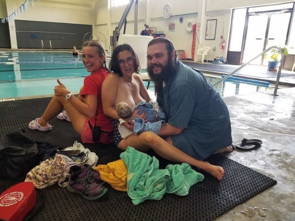 PHOTO: YMCA lifeguard Natalie Lucas and YMCA members Tessa and Matthew Rider after the Riders welcomed their third child on the pool deck, July 24, 2022, at the Y in Longmont, Colo.