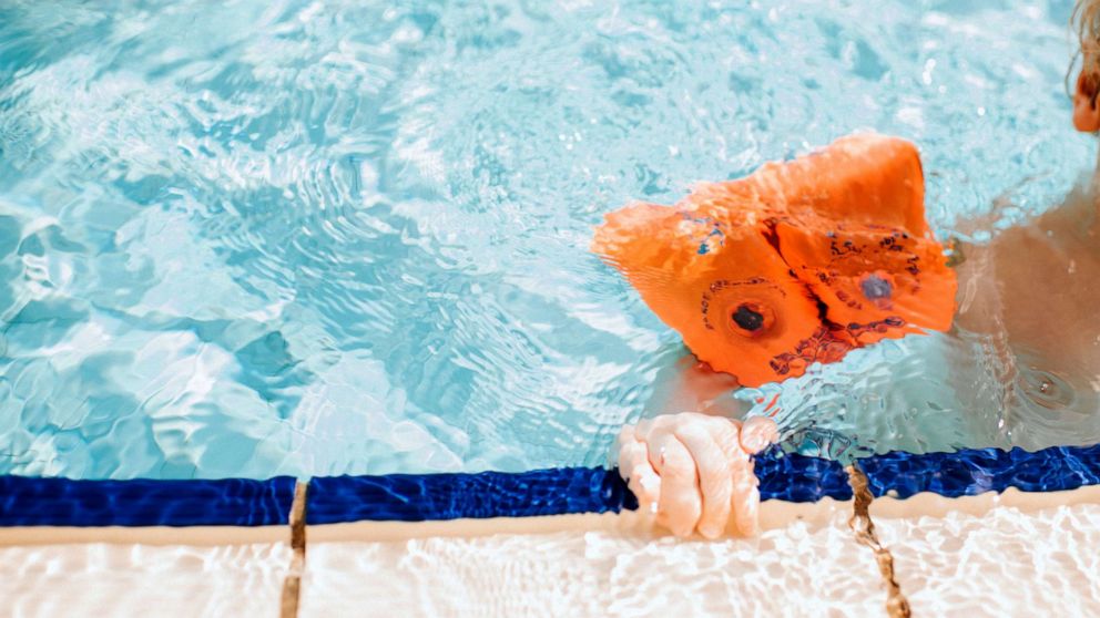 PHOTO: Stock photo of a child learning to swim in a pool.