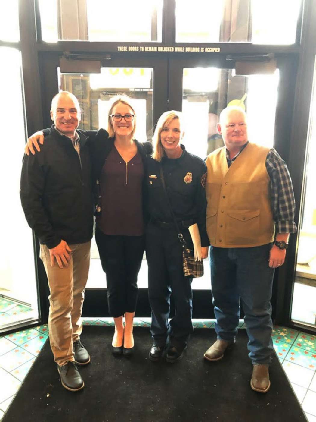 PHOTO: Lt. Tracy Post, second from right, poses with friends and colleagues after getting coverage for firefighters with breast cancer in Colorado.