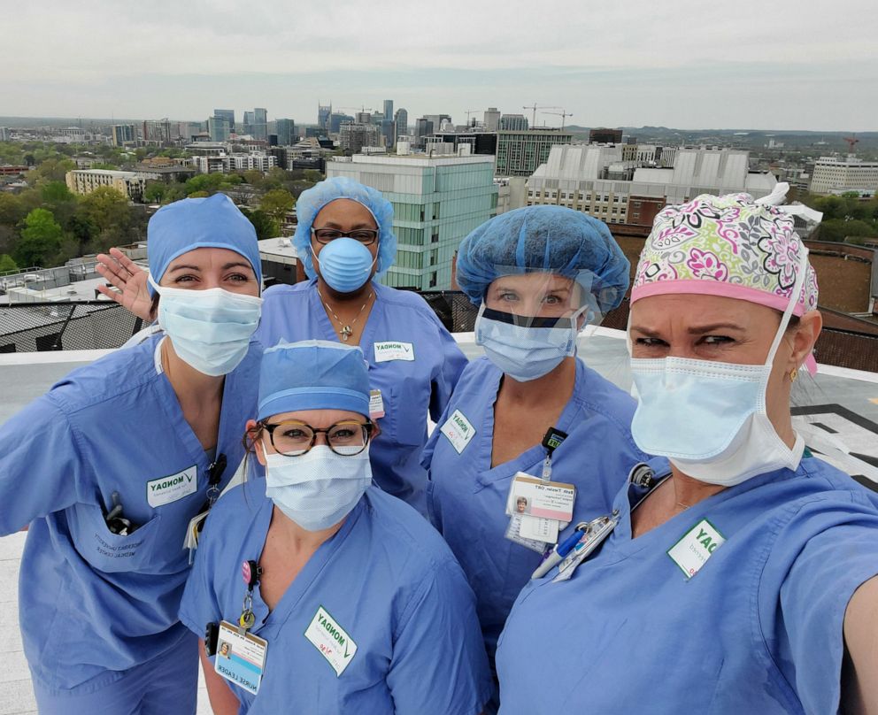 PHOTO: A group of nurses at the Vanderbilt University Medical Center in Nashville pray together on the hospitals helipad.