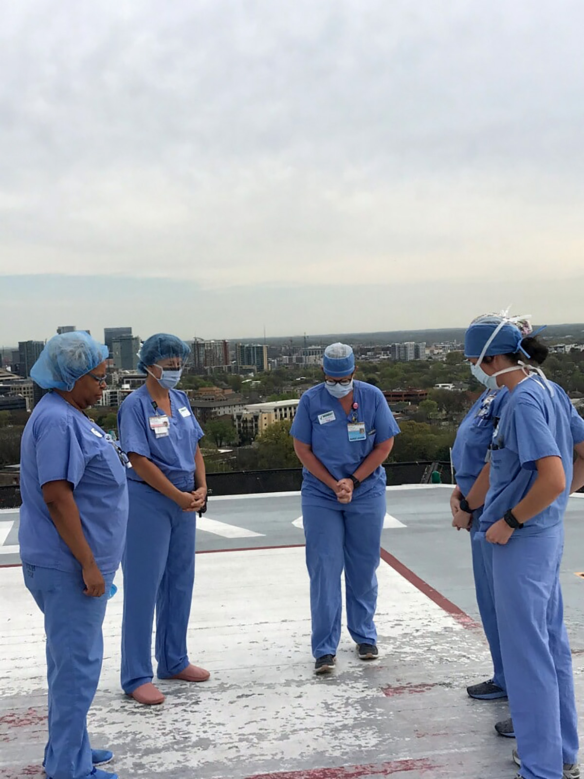 PHOTO: A group of nurses at the Vanderbilt University Medical Center in Nashville pray together on the hospitals helipad.