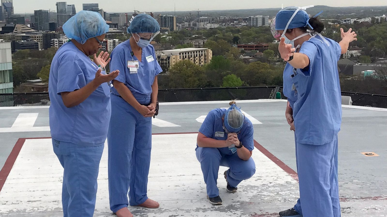 PHOTO: A group of nurses at the Vanderbilt University Medical Center in Nashville pray together on the hospitals helipad.