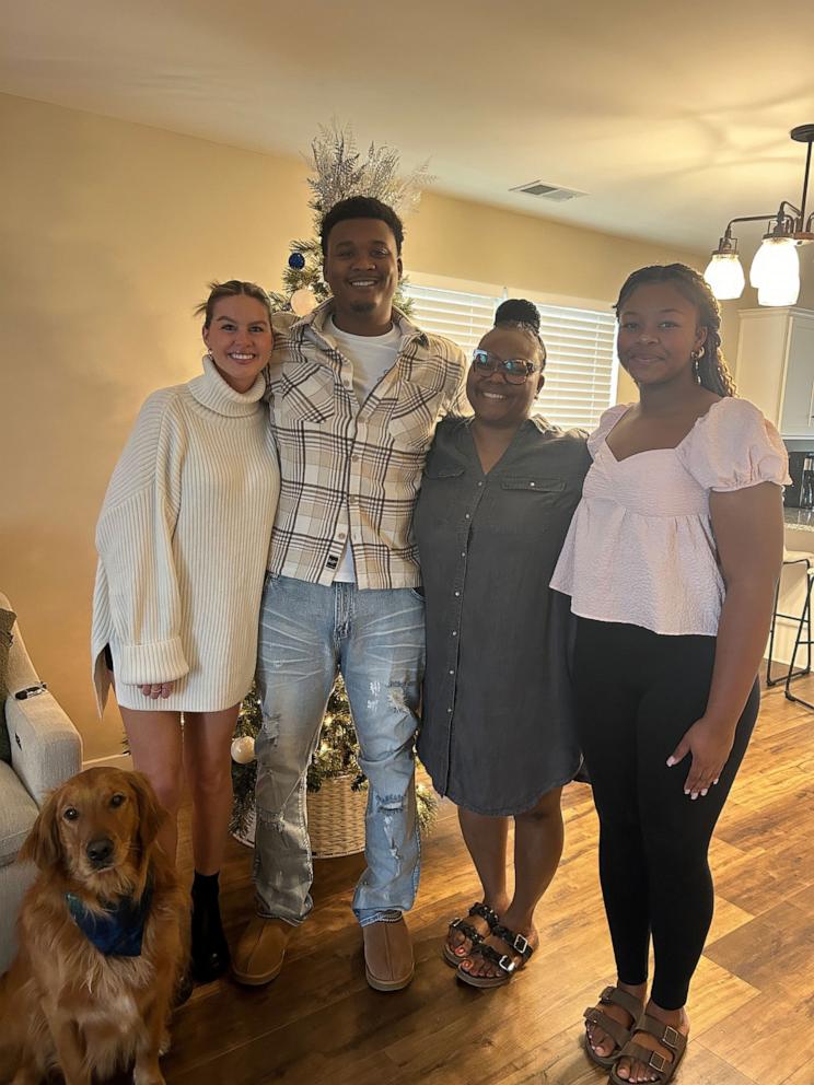 PHOTO: Olivia Walker, her husband Dalaino Walker and their dog smile for a photo with Dalaino Walker’s mom Latoya Chambers and sister Trinity Chambers.