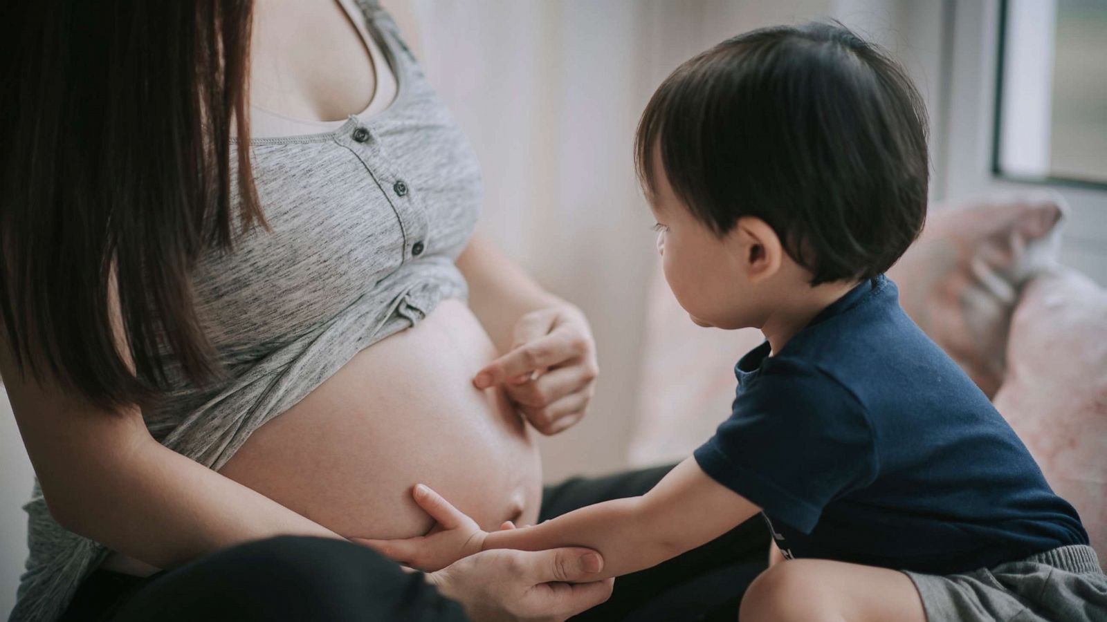 PHOTO: In this undated file photo, a toddler touches his mother's belly in anticipation of his new sibling being born.