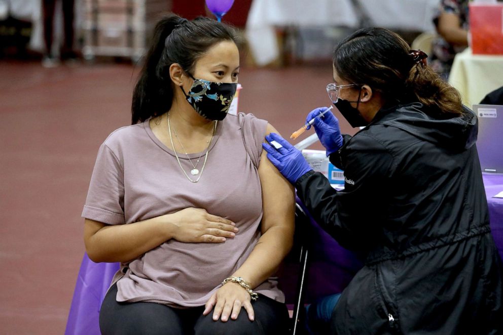 PHOTO: Nicole Fahey, six months pregnant, receives a Pfizer COVID0-19 booster shot from RN Veronique Vida at Eugene A. Obregon Park on Nov. 3, 2021, in Los Angeles.