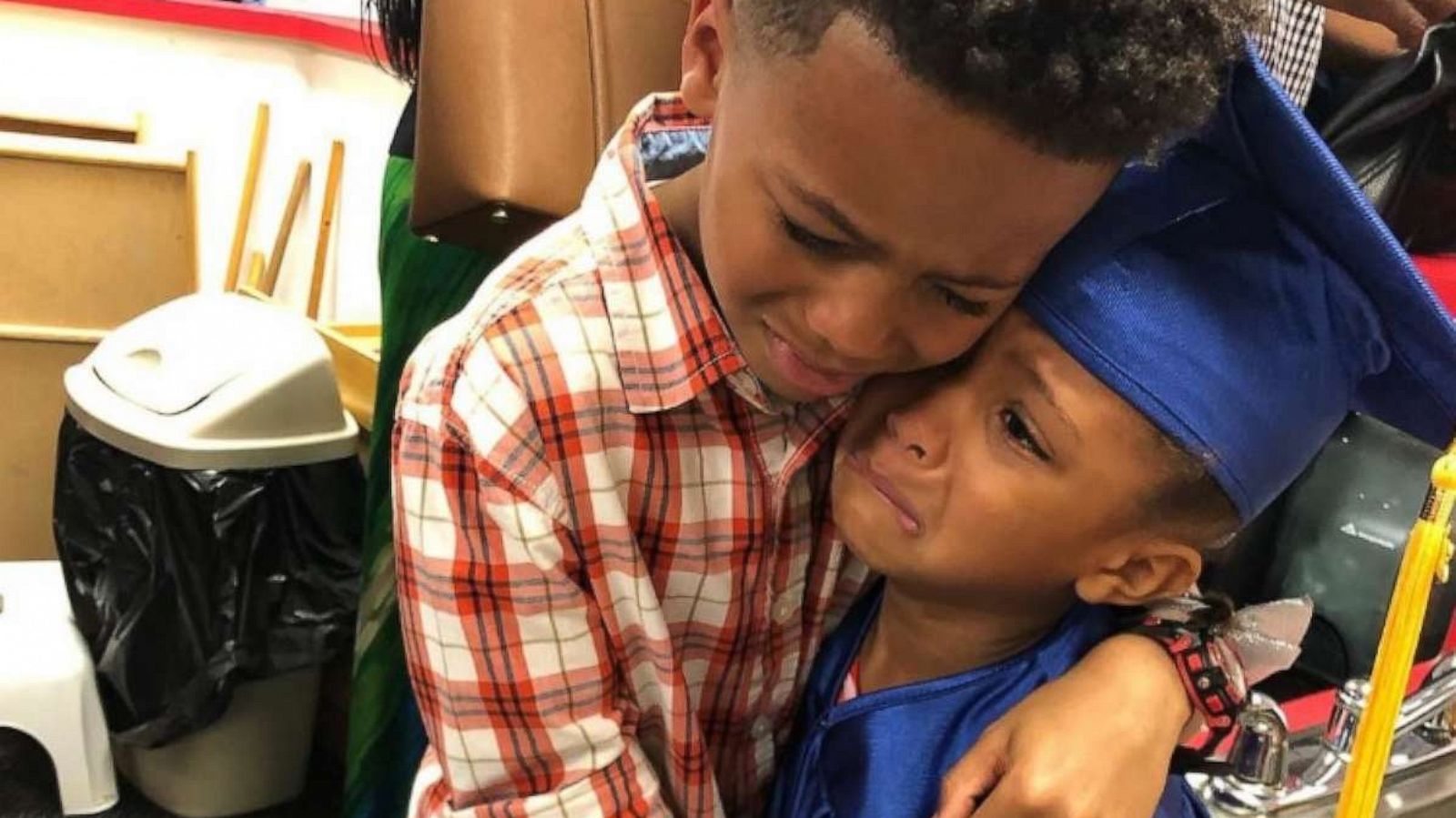 PHOTO: Derek Smith, 8, shares a hug with his sister Charlee Smith, 5, after her preschool graduation on June 21.