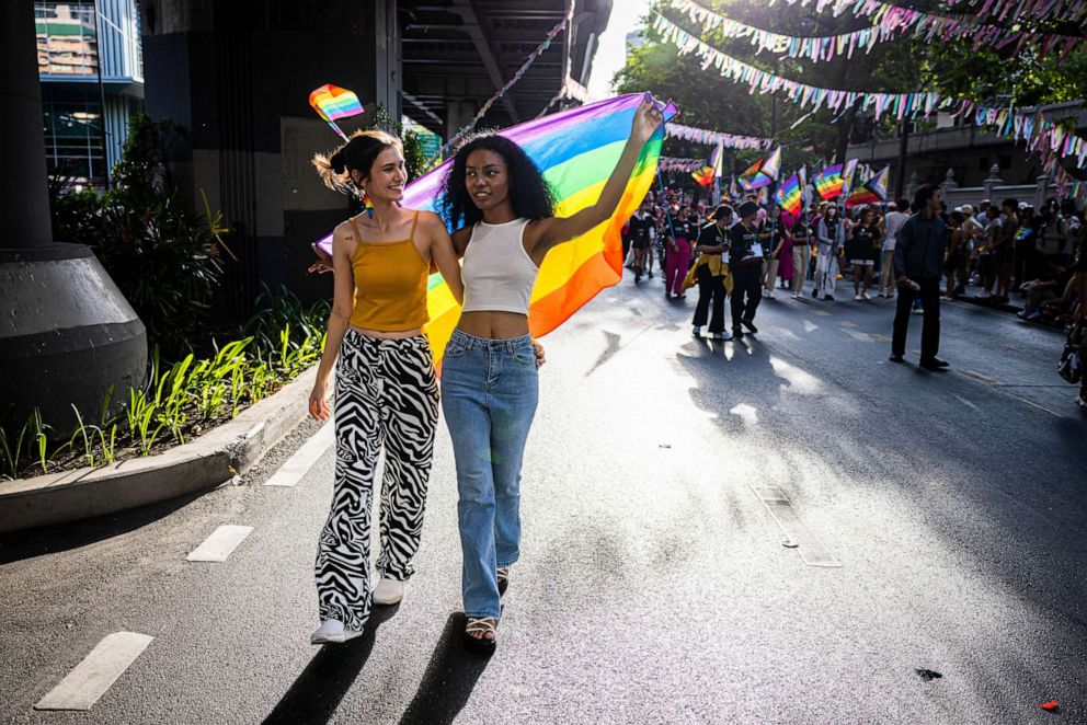 PHOTO: Attendees wave a rainbow flag during a Pride parade on June 4, 2023 in Bangkok.