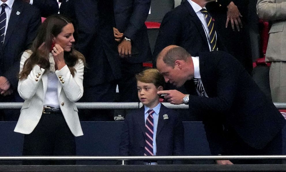 PHOTO: Britain's Prince William speaks to Prince George while Catherine, Duchess of Cambridge looks on, as they attend the Euro 2020 Championship Final football game between Italy and England at Wembley Stadium on July 11, 2021 in London.