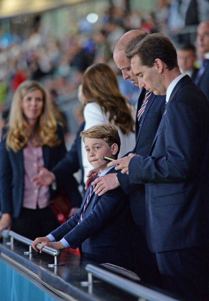 PHOTO: Britain's Prince William, Catherine, Duchess of Cambridge and Prince George attend the Euro 2020 Championship Final football game between Italy and England at Wembley Stadium on July 11, 2021 in London.