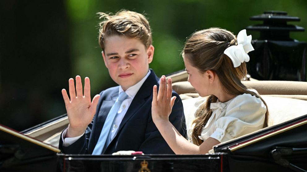 PHOTO: Prince George of Wales and Princess Charlotte of Wales make their way back to Buckingham Palace from Horse Guards Parade during the King's Birthday Parade "Trooping the Colour" in London on June 13, 2026.