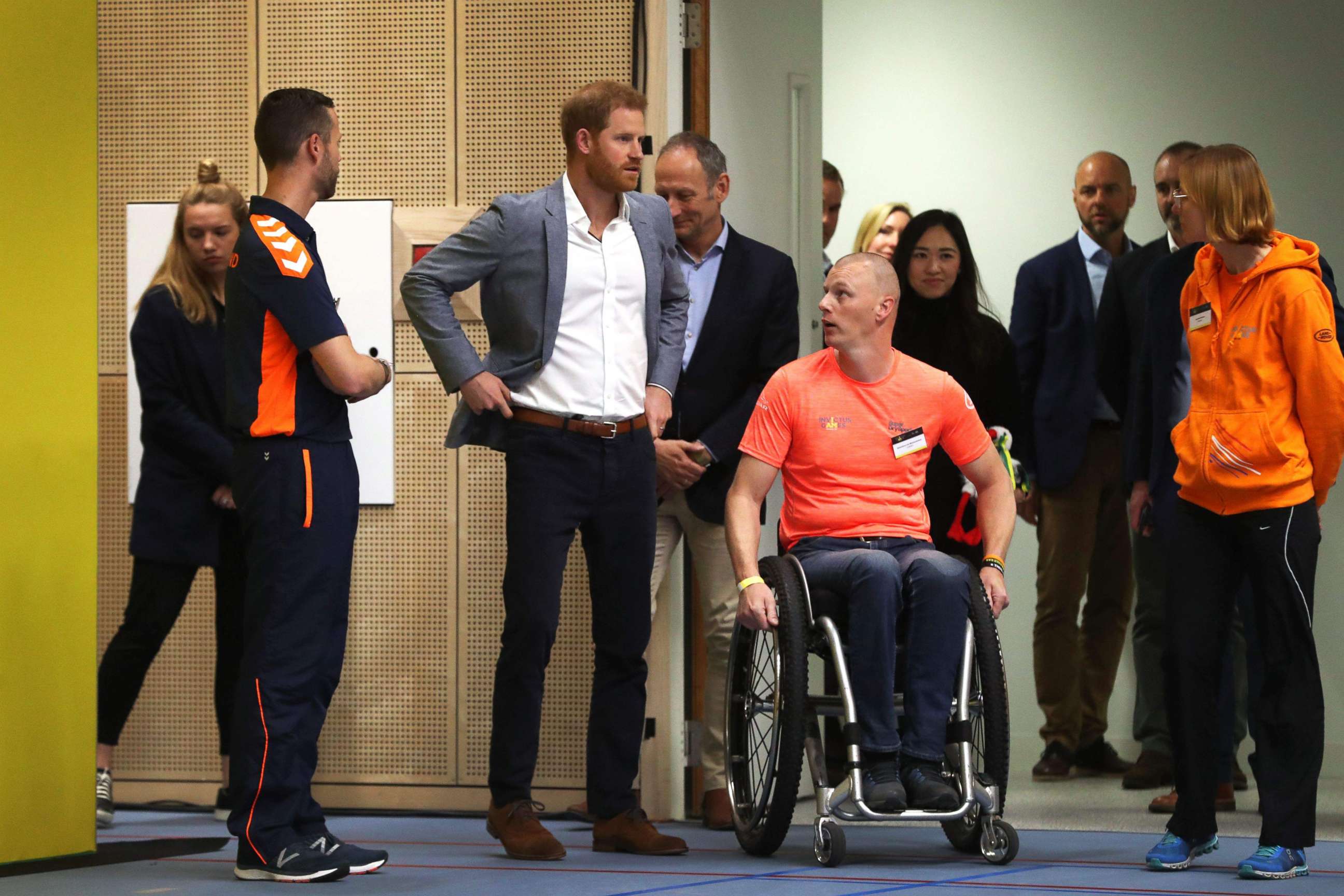 PHOTO: Britain's Prince Harry speaks with officials as he watches a basketball game in The Hague, May 9, 2019, ahead of The Invictus Games The Hague 2020.
