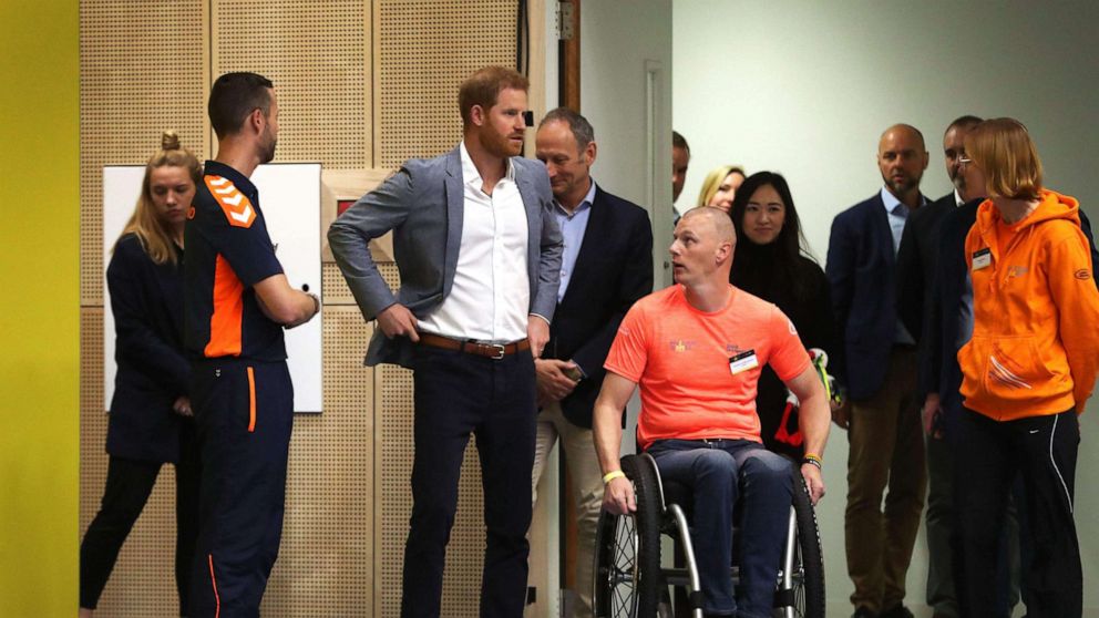 PHOTO: Britain's Prince Harry speaks with officials as he watches a basketball game in The Hague, May 9, 2019, ahead of The Invictus Games The Hague 2020.