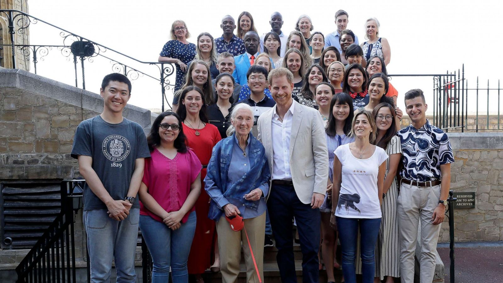 PHOTO: Prince Harry and Dr Jane Goodall pose for a photograph with Bella the Cockapoo and young people, as he attends Dr Jane Goodall's Roots & Shoots Global Leadership Meeting at St. George's House, Windsor Castle in England, July 23, 2019.