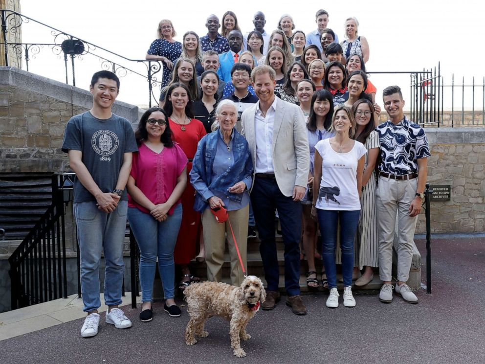 PHOTO: Prince Harry and Dr Jane Goodall pose for a photograph with Bella the Cockapoo and young people, as he attends Dr Jane Goodalls Roots & Shoots Global Leadership Meeting at St. Georges House, Windsor Castle in England, July 23, 2019.