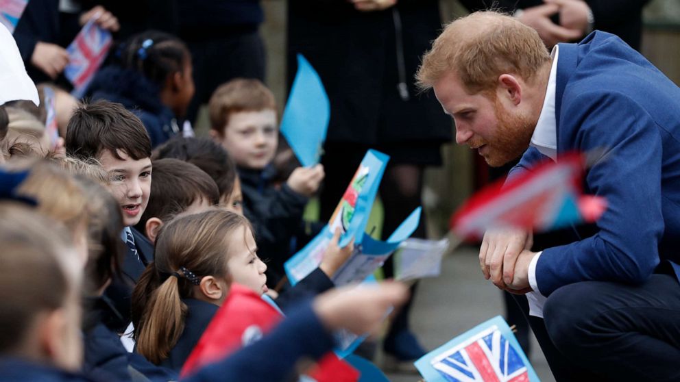 PHOTO: Prince Harry, Duke of Sussex greets school children after planting a tree from the Woodland Trust at St Vincent's Catholic Primary School, March 20, 2019, in Acton, England.