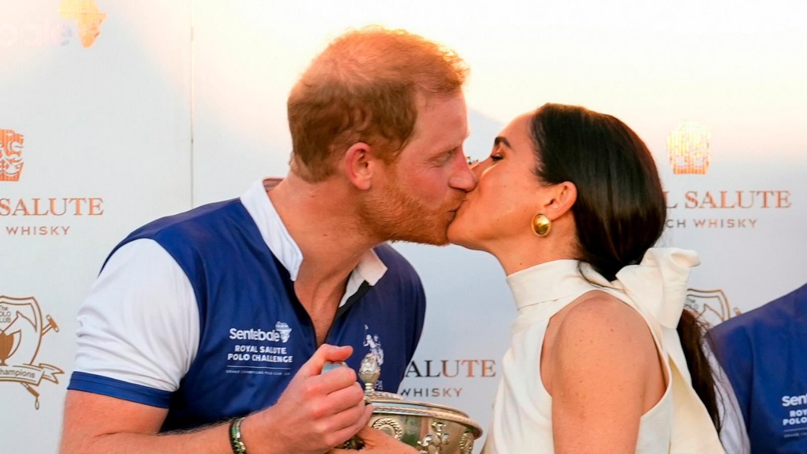 PHOTO: Britain's Prince Harry, left, and wife, Meghan Markle, Duchess of Sussex, kiss as she presents members of his polo team with the trophy for winning the Royal Salute Polo Challenge to Benefit Sentebale, on April 12, 2024, in Wellington, Fla.