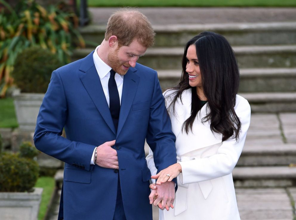 PHOTO: British Prince Harry and Meghan Markle pose for media in the precincts of Kensington Palace in London on November 27, 2017.