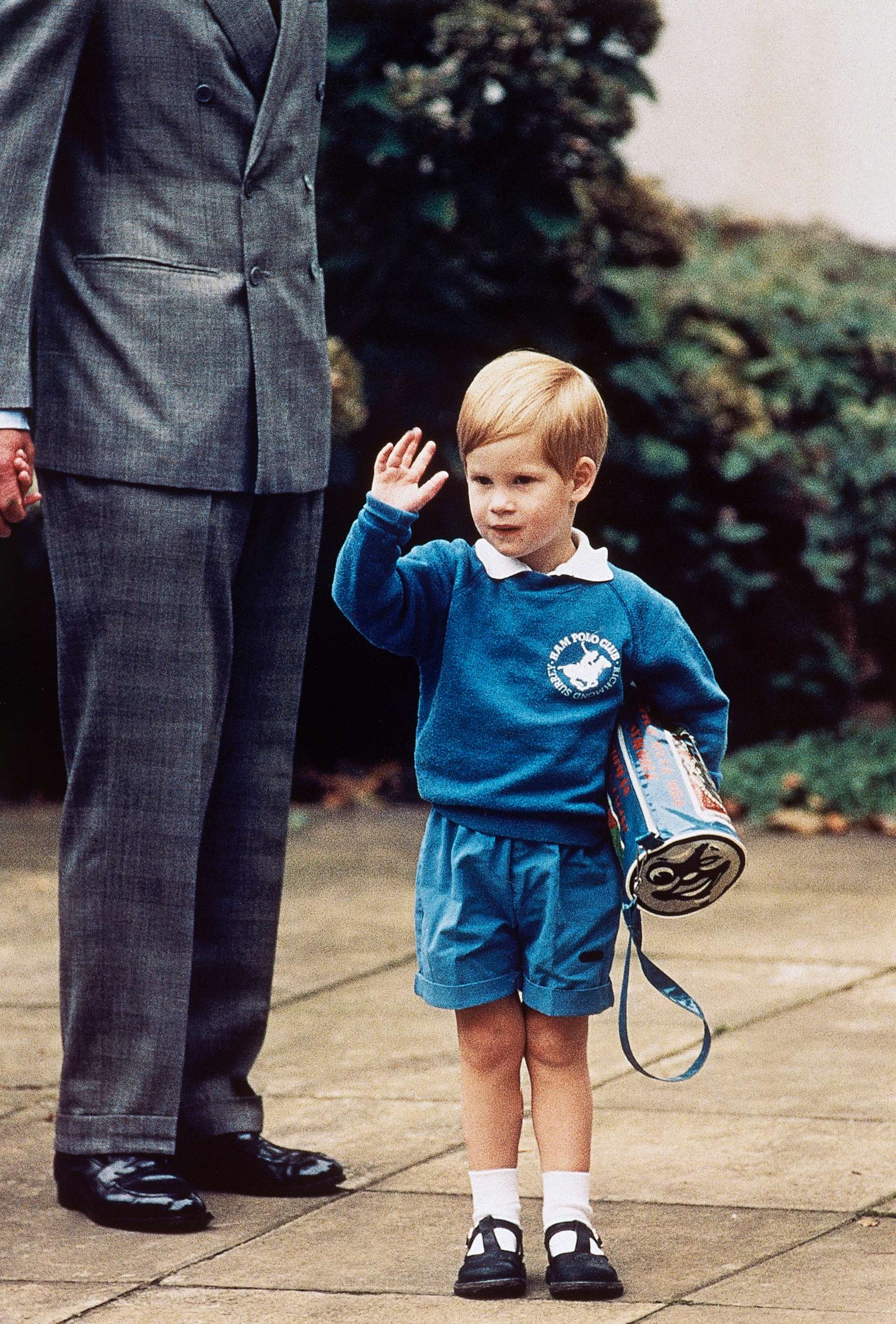 PHOTO: Britain's Prince Harry waves to photographers while holding a Thomas The Tank Engine bag on his first day at a kindergarten in Notting Hill, West London, Sept. 16, 1987.