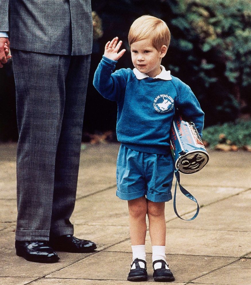 PHOTO: Britain's Prince Harry waves to photographers while holding a Thomas The Tank Engine bag on his first day at a kindergarten in Notting Hill, West London, Sept. 16, 1987.