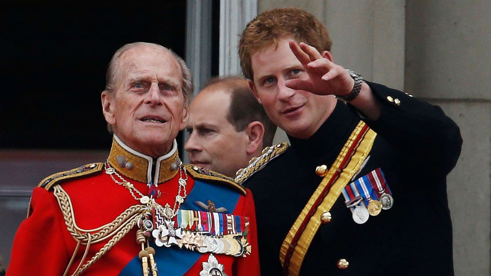 PHOTO: Britain's Prince Harry talks to Prince Philip as members of the Royal family appear on the balcony of Buckingham Palace, during the Trooping The Colour parade, in central London, June 14, 2014.