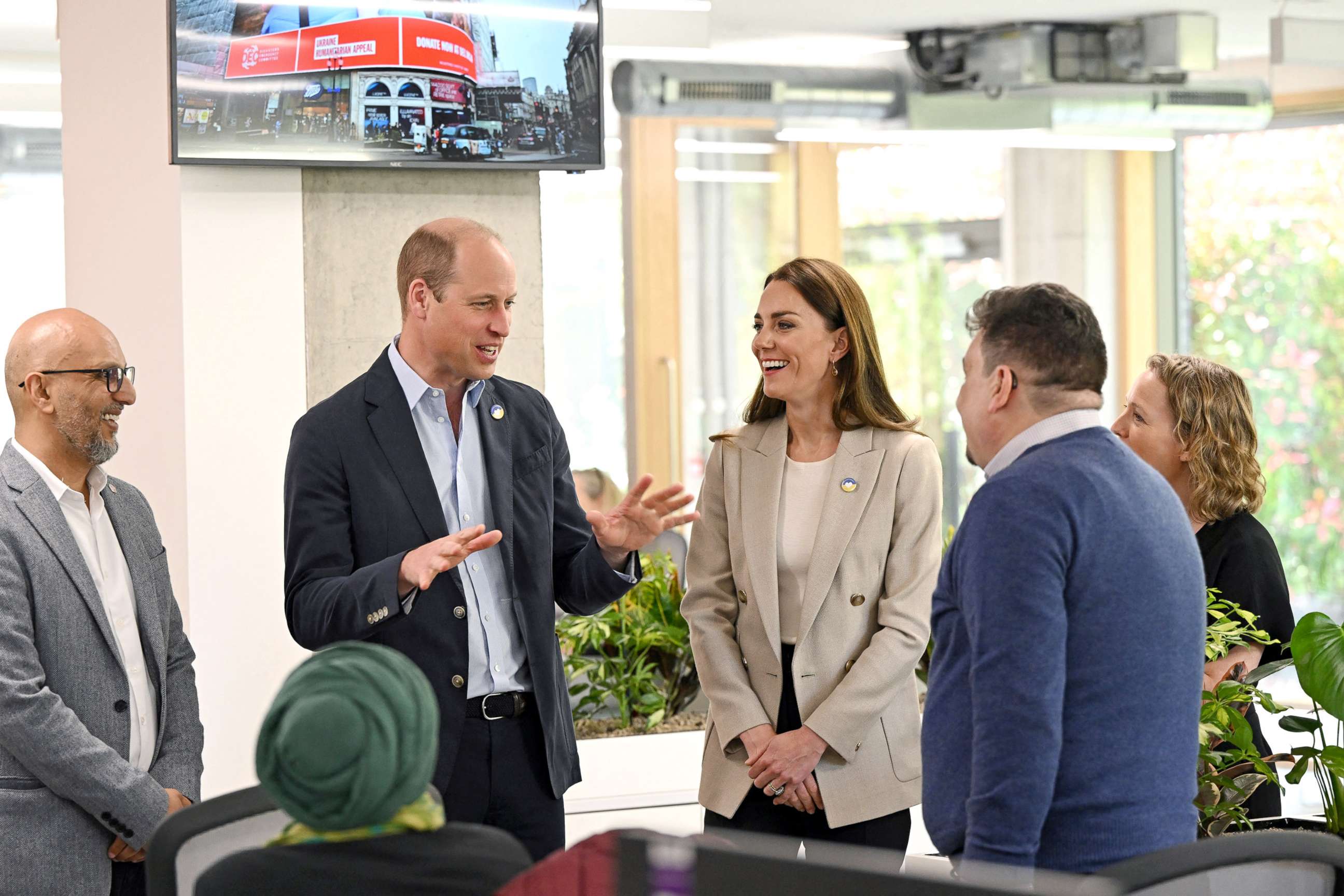 PHOTO: Disasters Emergency Committee (DEC) CEO Saleh Saeed tours the organization's facility with British Prince William, Duke of Cambridge, and Catherine, Duchess of Cambridge, during their visit at the London headquarters in London, April 21, 2022. 