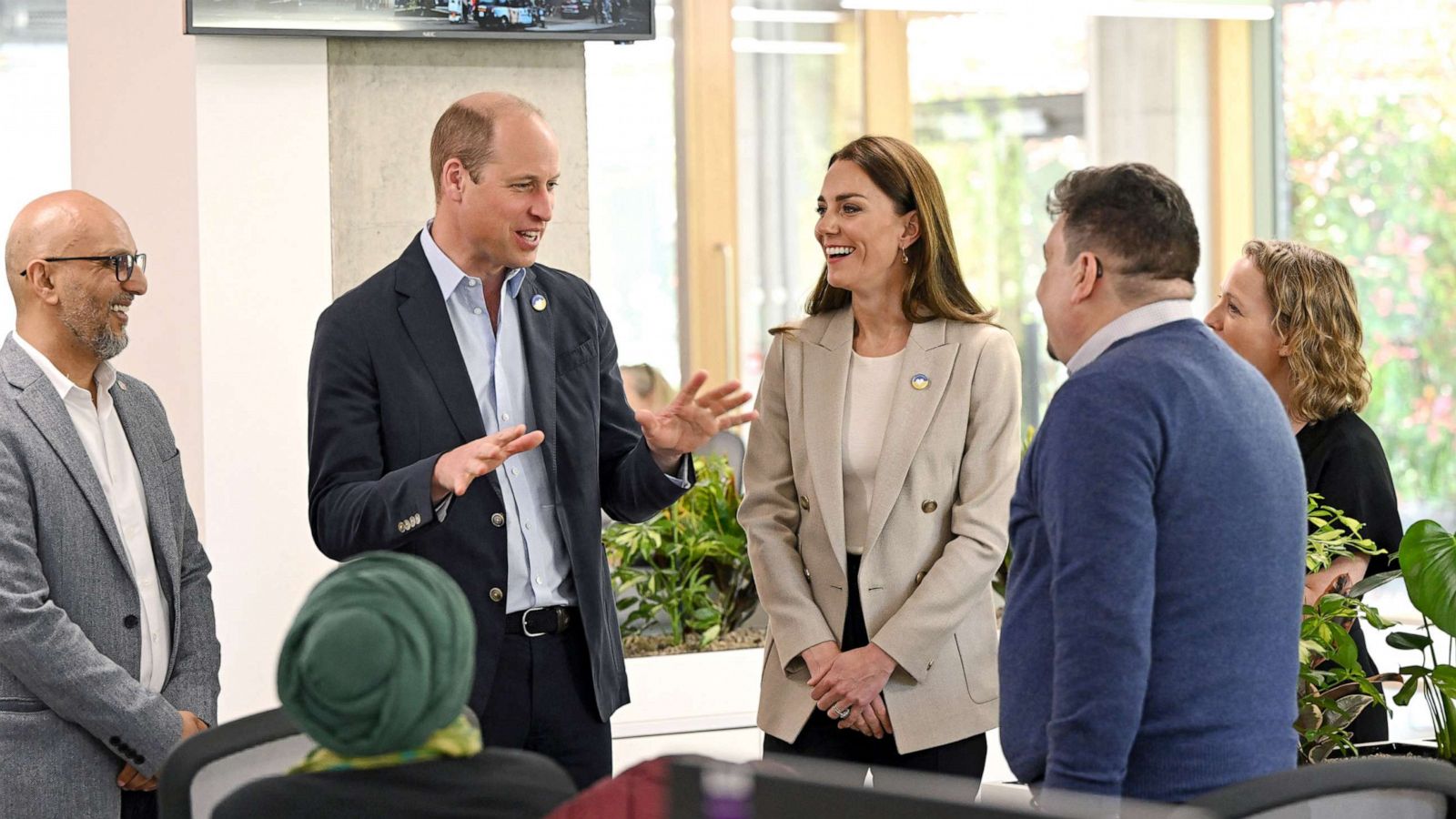 PHOTO: Disasters Emergency Committee (DEC) CEO Saleh Saeed tours the organization's facility with British Prince William, Duke of Cambridge, and Catherine, Duchess of Cambridge, during their visit at the London headquarters in London, April 21, 2022.